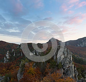 Scenic landscape in Sulov, Slovakia, on beautiful autumn sunrise with colorful leaves on trees in forest and bizarre pointy rocks