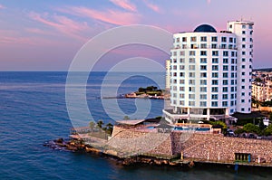 Scenic landscape view of high-rise hotel with open air pool in the seashore of the Mediterranean Sea near Mersin in Turkey