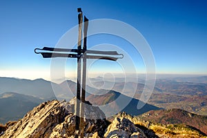 Scenic landscape view of mountain peak with metal cross