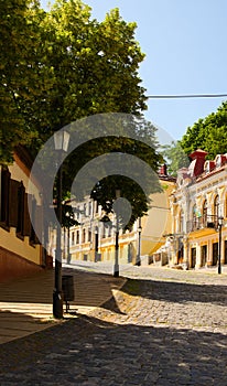 Scenic landscape view of vintage colorful buildings on ancient  Andriyivskyy Uzvoz Descent or Spusk. Sunny summer morning. photo