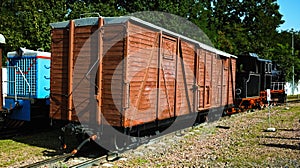 Scenic landscape view of vintage steam train locomotive type GR with old wooden freight wagon