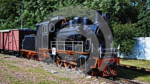 Scenic landscape view of vintage steam train locomotive type GR with old wooden freight wagon