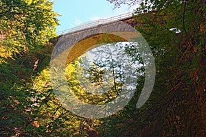 Scenic landscape view of Vintgar Gorge Bled Gorge. Arc stone bridge over gorge. Sunny autumn day