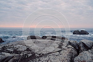 Scenic landscape of waves lapping against a rocky ocean shoreline