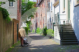 Senior man between scenic medieval Wall Houses,Amersfoort, Netherlands