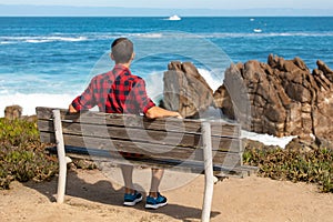 Scenic Monterey coast, travel man enjoying beautiful view of the Kissing Rock, Pacific Grove, Monterey, California, USA