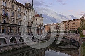 Scenic morning landscape of Ljubljana. Panoramic view of embankment of Ljubljanica River with Triple Bridge