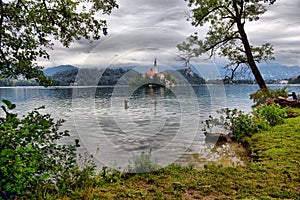 Scenic morning view of St. Martin`s Parish Church near Bled Lake. Beautiful autumn weather during sunrise.