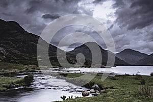 Scenic mountain valley with stream falling into the lake in Lake District,Cumbria,Uk