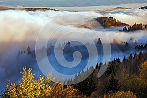 Scenic mountainous landscape hidden in a sea of clouds. Kremnica Mountains, Slovakia.