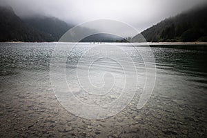 Scenic mystical cloudy lago di predil, italy photo