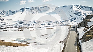 Scenic Norwegian Wilderness Road Covered by Snow and a Camper Van