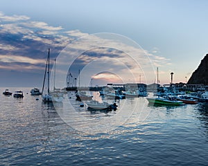 Scenic ocean, island sunrise, bay view of sailboats, yachts, fishing boats in Catalina Island harbor