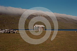 Scenic old hut isolated against a narrow river