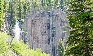 Scenic Palisade Falls flowing over steep cliff in a lush Montana forest