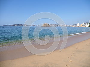 Scenic panorama of Pacific Ocean waves on sandy beach landscape at bay of ACAPULCO city in Mexico