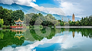 Scenic panorama of reflection park pond with the Three Pagodas and Cangshan mountains in background Dali Yunnan China