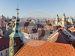 Scenic panoramic aerial drone view of rooftops of medieval city center, town hall and cathedral church in Ljubljana