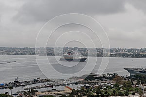 Scenic panoramic aerial view of the San Diego Bay on a heavily overcast day, with a cruise ship at a distance, California