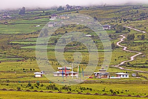 Scenic panoramic view of green field with buildings and roads