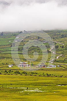 Scenic panoramic view of green field with buildings and roads