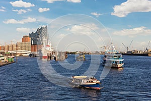 Scenic panoramic view of Hansestadt Hamburg Elbe harbor port with many tourist ship trip Elbphilarmonie concert hall in