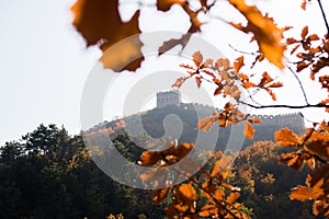 Scenic panoramic view of a hill with a portion of the Great Wall close to Jinshanling, on a sunny day of autumn, in China