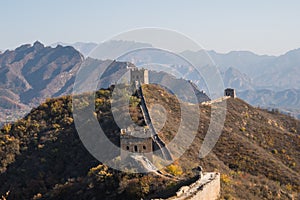 Scenic panoramic view of a hill with a portion of the Great Wall close to Jinshanling, on a sunny day of autumn, in China