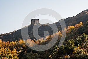 Scenic panoramic view of a hill with a portion of the Great Wall close to Jinshanling, on a sunny day of autumn, in China