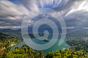 Scenic panoramic view of Lake Bled from above with moving clouds