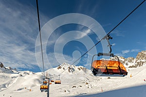 Scenic panoramic view of Silvretta ski area at Iscgl and Samnaun skiing resort with chairlifts , downhill slpoes and clear blue