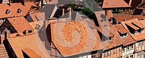 Scenic panoramic view traditional shingle tiled red rooftop old ancient medieval european german small town Quedlinburg