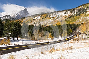 Scenic paved road after the first Fall snow storm in Rocky Mountain National Park, Colorado.