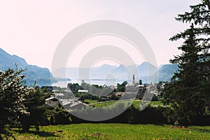 Scenic picture-postcard view of famous Hallstatt lakeside village in the Austrian Alps with passenger ship in beautiful morning
