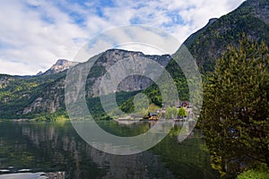 Scenic picture-postcard view of traditional old wooden houses in famous Hallstatt mountain village at Hallstattersee lake