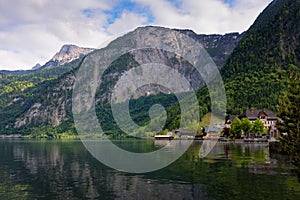 Scenic picture-postcard view of traditional old wooden houses in famous Hallstatt mountain village at Hallstattersee lake