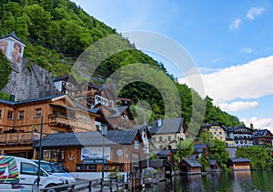 Scenic picture-postcard view of traditional old wooden houses in famous Hallstatt mountain village at Hallstattersee lake