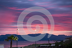 Scenic red sunrise over coastline with sandy beach and clear sea water in Alcamo Marina, small town in Sicily, Italy, summer