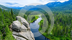 Scenic River Valley with Lush Green Forest and Mountains photo