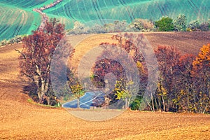 Scenic road through the autumn agricultural fields, colorful rural landscape
