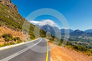 Scenic road at Franschhoek valley with its famous wineries and surrounding mountains