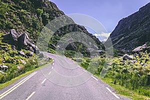 Scenic road of Gap of Dunloe, a narrow mountain pass in county Kerry, Ireland on a sunny day