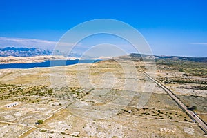 Scenic road on the island of Pag in Croatia, between old agriculture fields and stone drywals