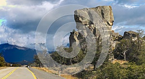 Scenic Road Leading Towards Dramatic Rock Formations