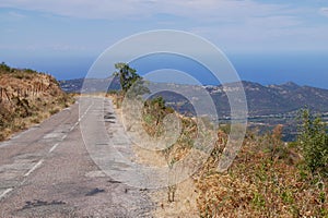 Scenic road overlooking the Mediterranean Sea winding through Balagne. Corsica, France.