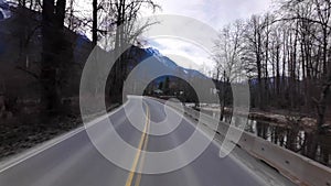 Scenic Road surrounded by Mountains and Trees on Cloudy Day. Spring Season. Highway in Pemberton