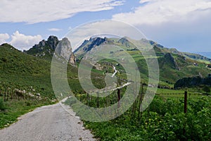 Scenic road winding through rolling hills and scenic mountains in fertile hinterland, Sicily, Italy.