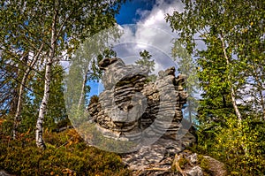 Scenic rock formation in autumn birch forest near stone labyrinth Bledne skaly in Szczeliniec Wielki