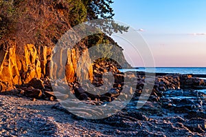 Scenic rocky beach Cala Violina landscape at the sunset. Tyrrhenian Sea bay at the sunset