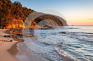 Scenic rocky beach Cala Violina landscape at the sunset. Tyrrhenian Sea bay at the sunset